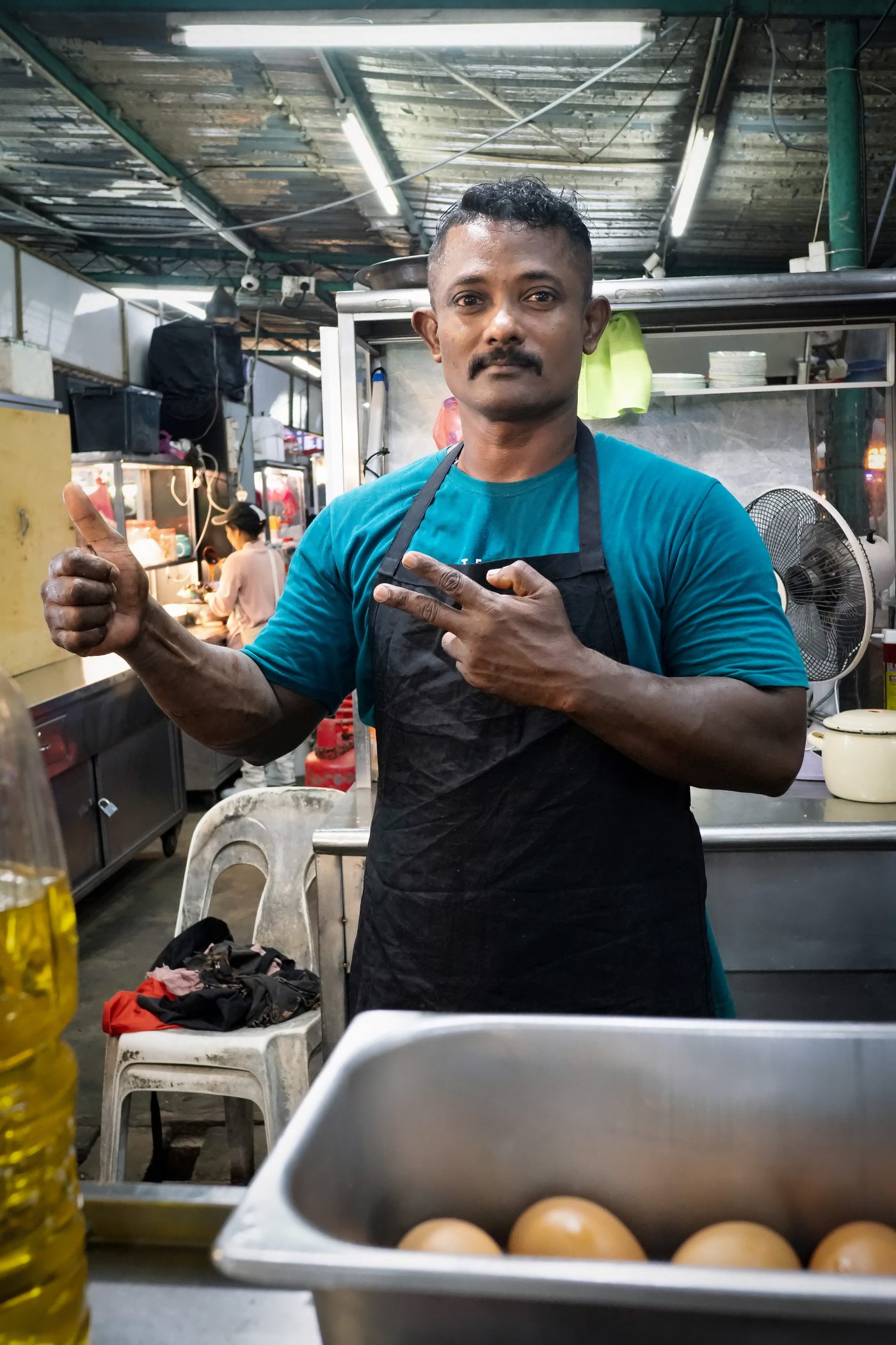 Seller at the Mee Rebus stall at 33 Best Food Hub